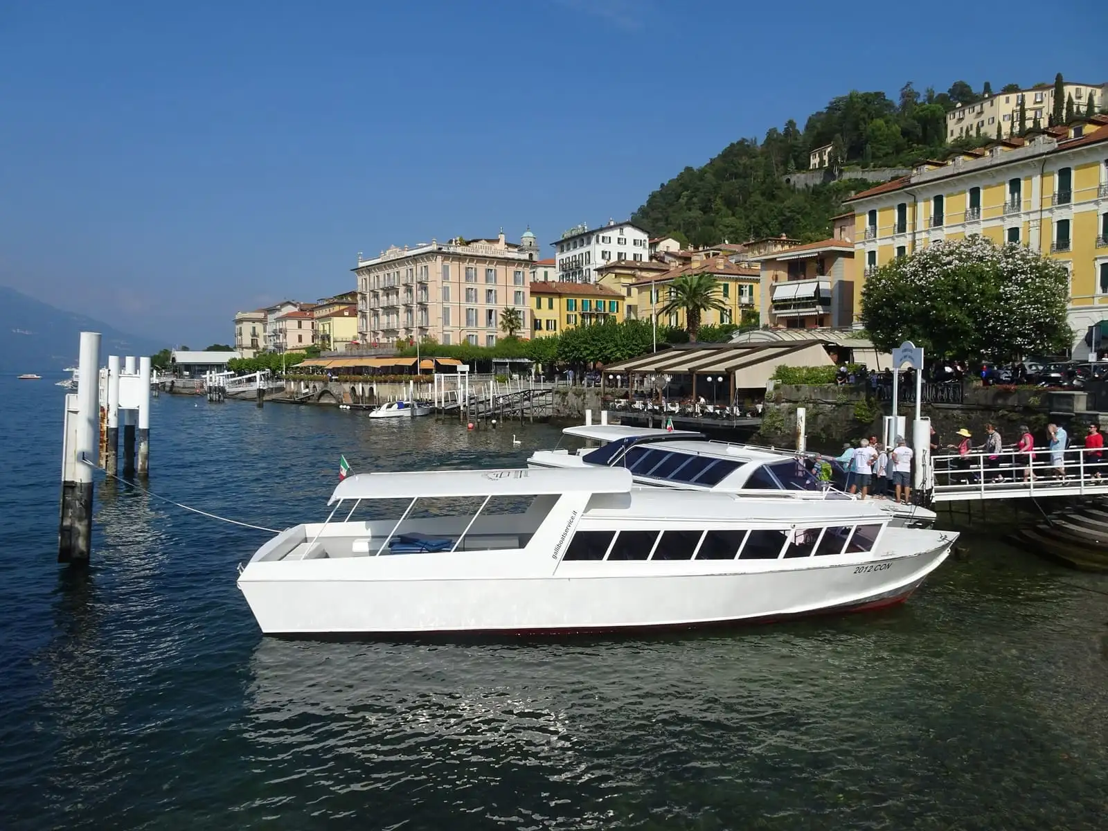 Bellagio waterfront on Lake Como with a passenger boat at the landing