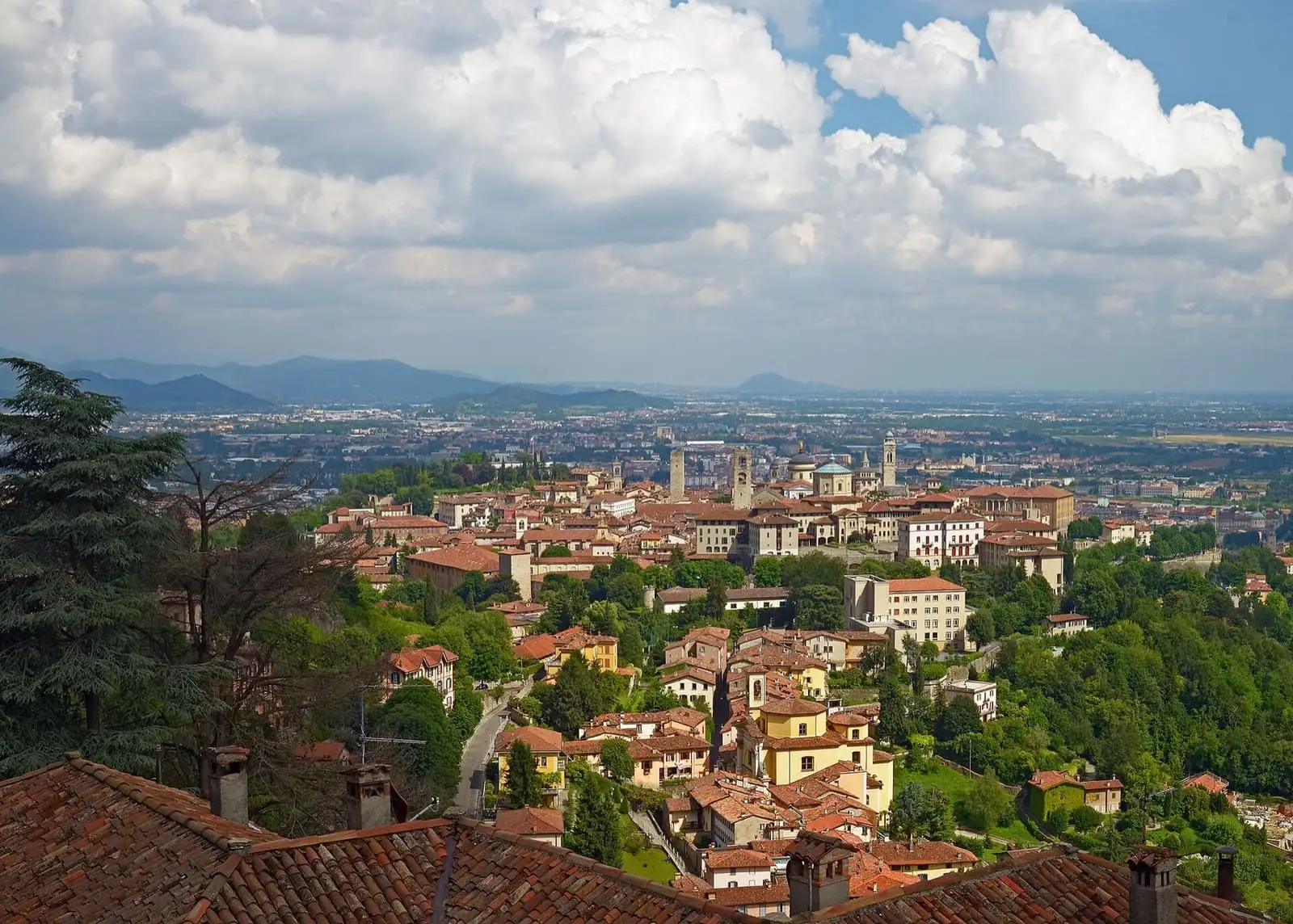 Rooftops and towers of Bergamo's walled upper town, Città Alta, seen from Via al Castello