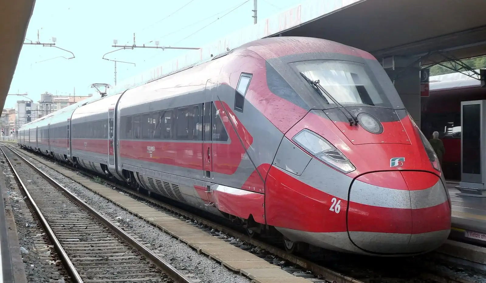 Red Trenitalia Frecciarossa 1000 high-speed train at a platform in Torino Porta Nuova station