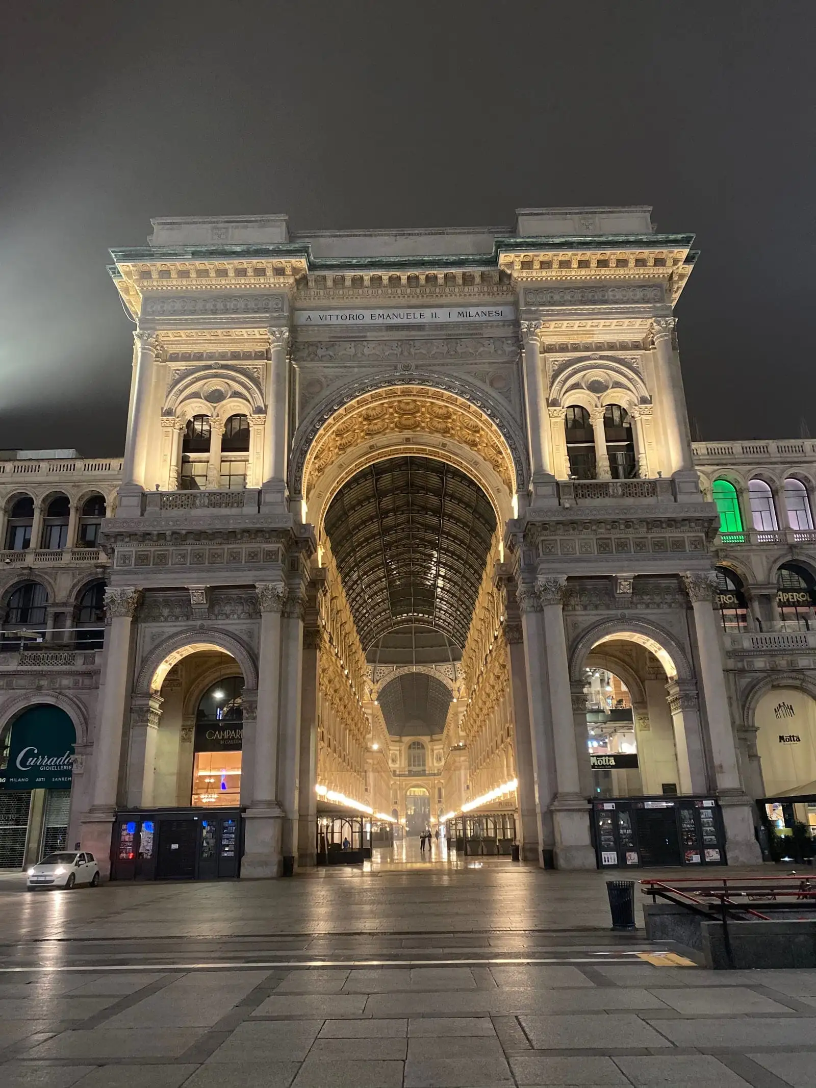 The triumphal arch entrance of Galleria Vittorio Emanuele II lit up at night