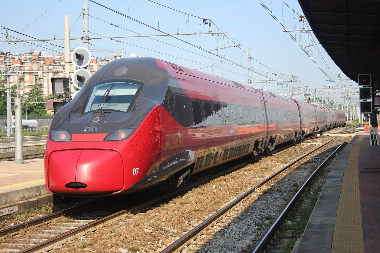 Burgundy Italo EVO high-speed train leaving Venezia Mestre station