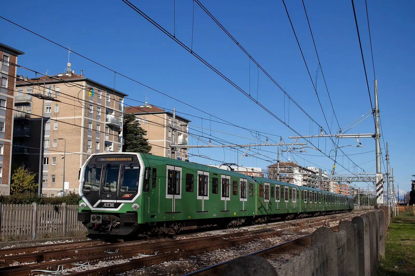 A green Leonardo train of the Milan metro M2 line on an above-ground stretch