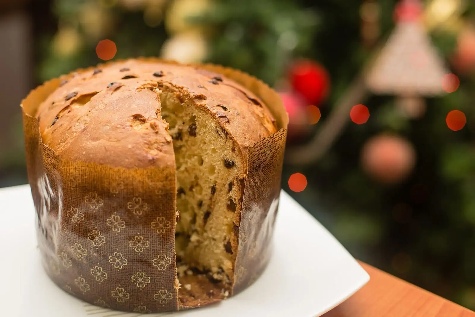 Panettone cut open to show the soft crumb with raisins and candied peel
