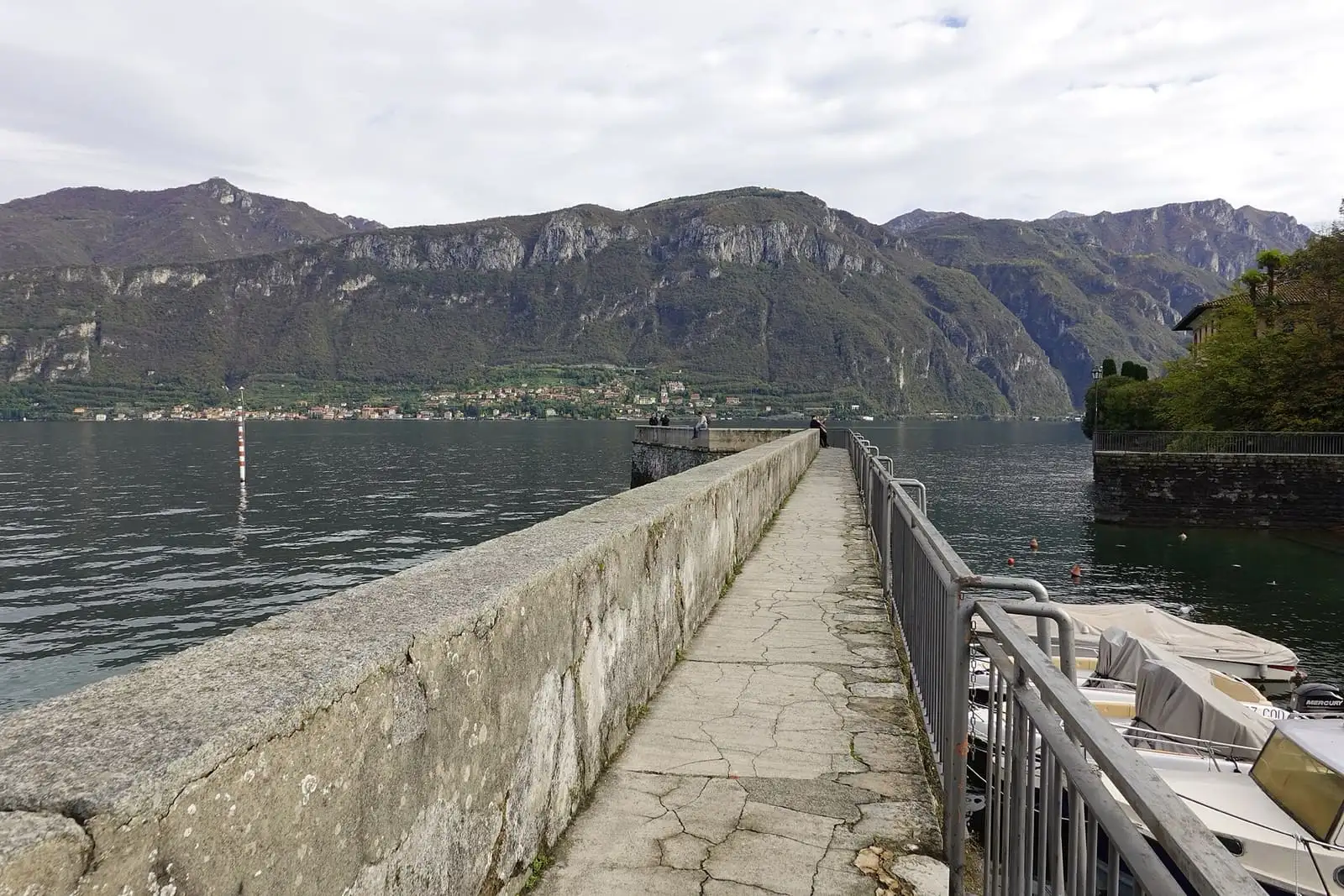 Stone jetty at Punta Spartivento in Bellagio, with Lake Como and mountains across the water
