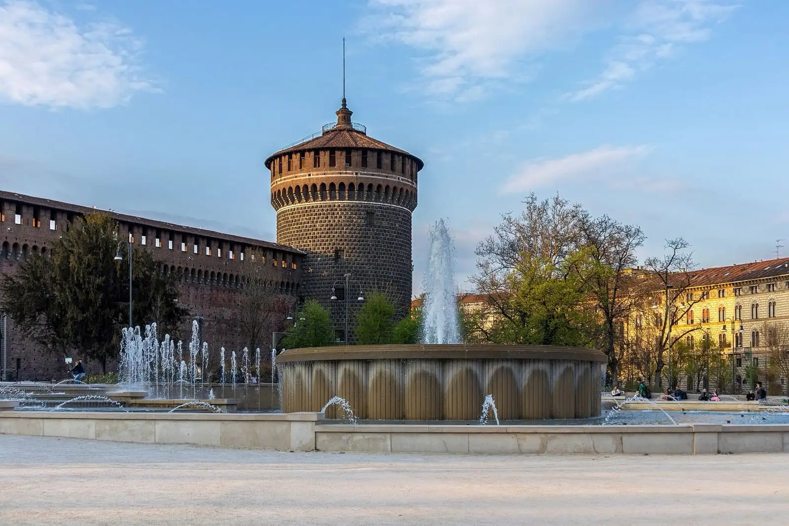 Torrione del Carmine tower of Sforza Castle behind the fountain in Piazza Castello, Milan