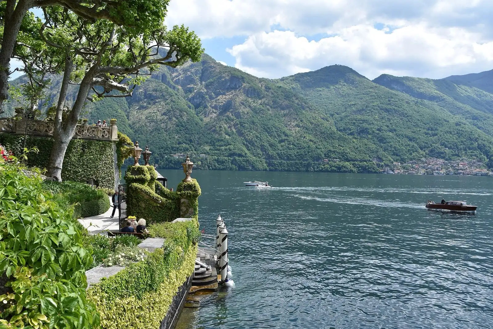Terraced gardens of Villa del Balbianello above Lake Como, with a boat passing on the water